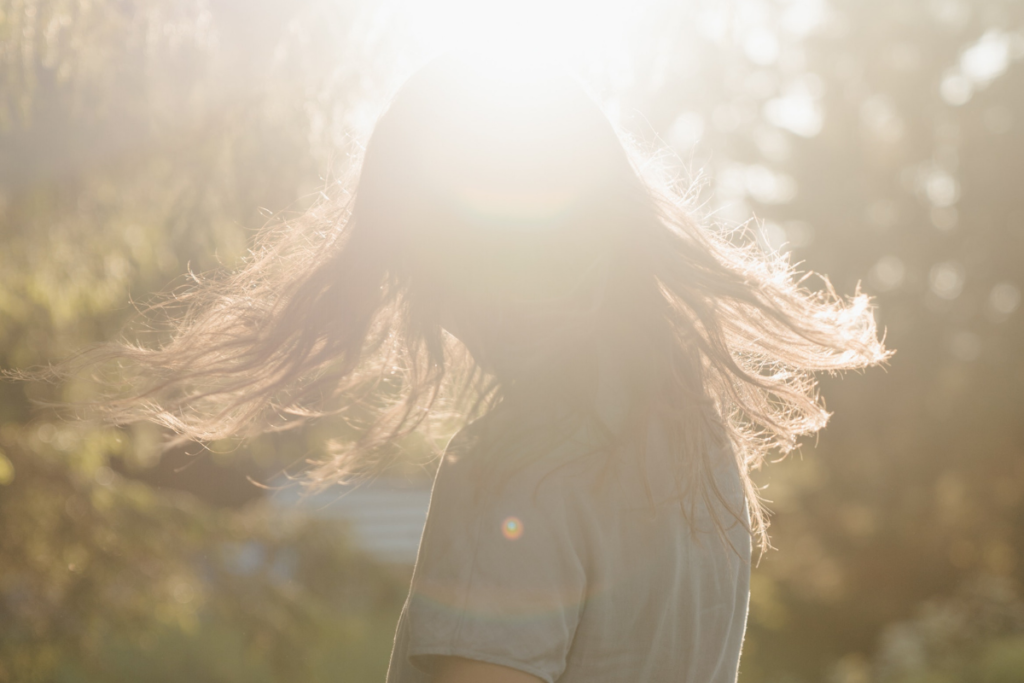 Girl standing in the sun
